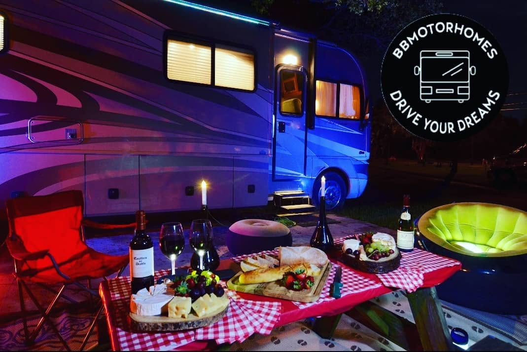Evening campsite setup beside a motorhome, BB Motorhomes — Drive Your Dreams