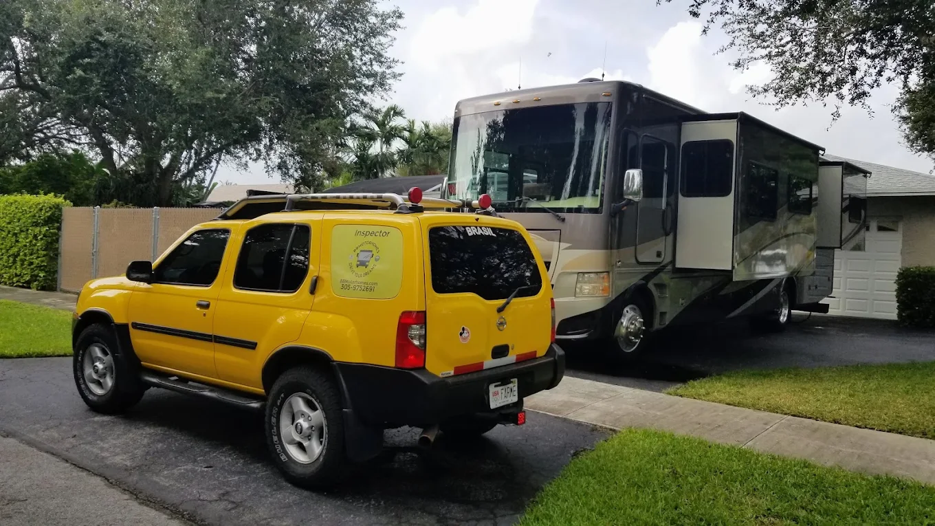 BB Motorhomes inspector vehicle beside a Class A motorhome at a driveway appointment